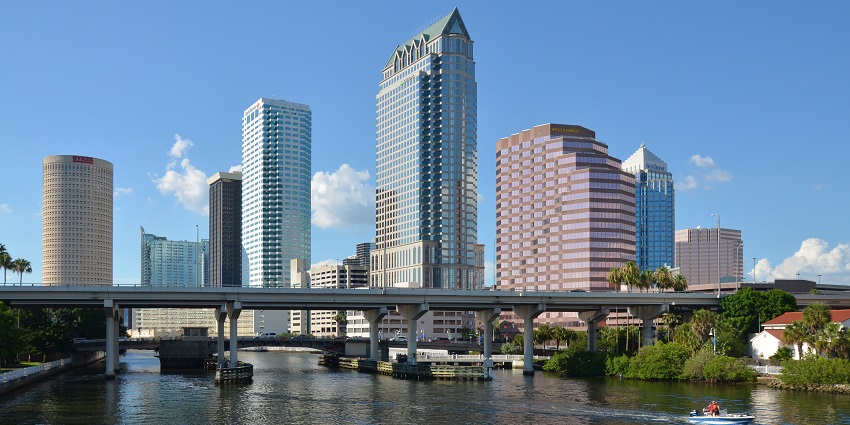 Shining skyscrapers of Downtown Tampa near a bridge in Florida, United States.