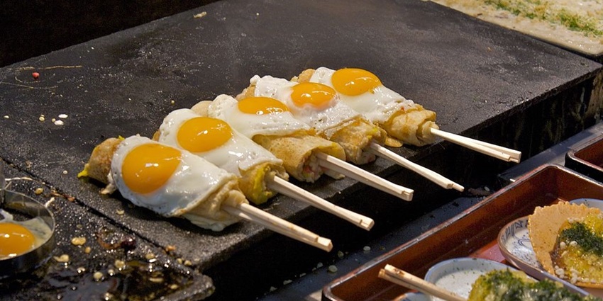 Taste Osaka’s famous street food, including takoyaki and okonomiyaki.
