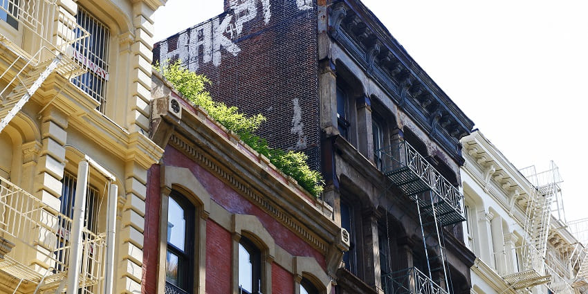 Cast-iron buildings of Soho with graffiti painted on the walls, one of the best things to see in New York.