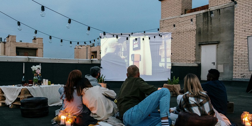 An image of a Group of people watching street cinema, enjoying an intimate Valentine's Day event in Los Angeles.