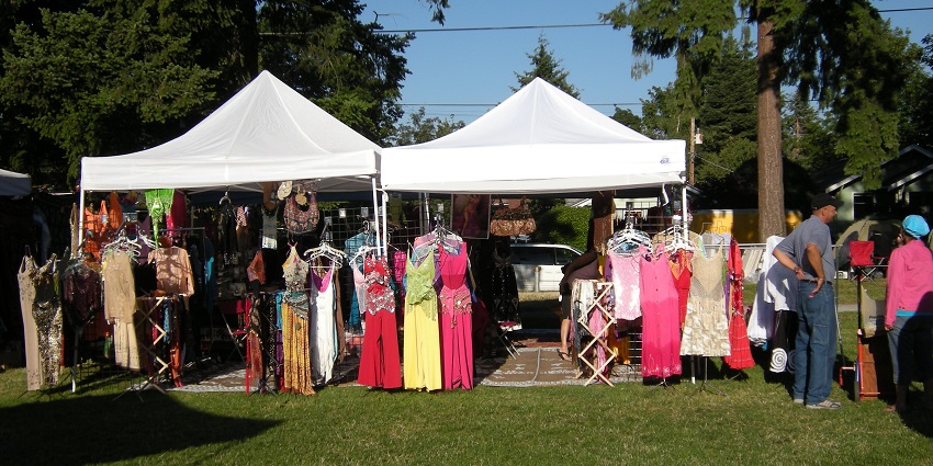 Mediterranean festival with stalls selling clothes, handicrafts and a lady looking at them.