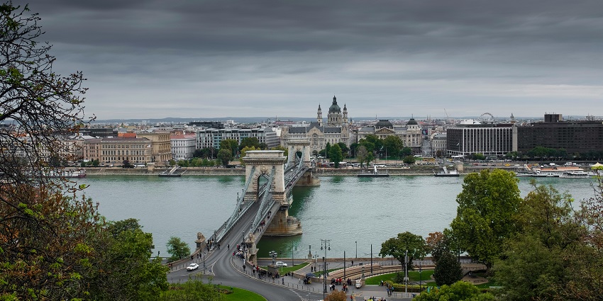 A river cruise ship, sailing on the Danube River in Budapest, with scenic views.