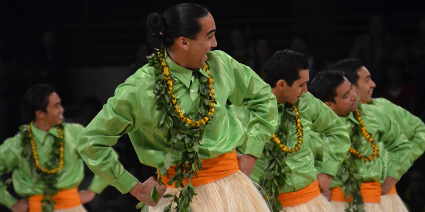 Hula Dancers wearing a garland of flowers and leaves perform at Merrie Monarch Festival, Hawaii.