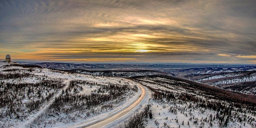 An image of an aerial view of Fairbanks, Alaska with snow-covered terrain and distant mountains.