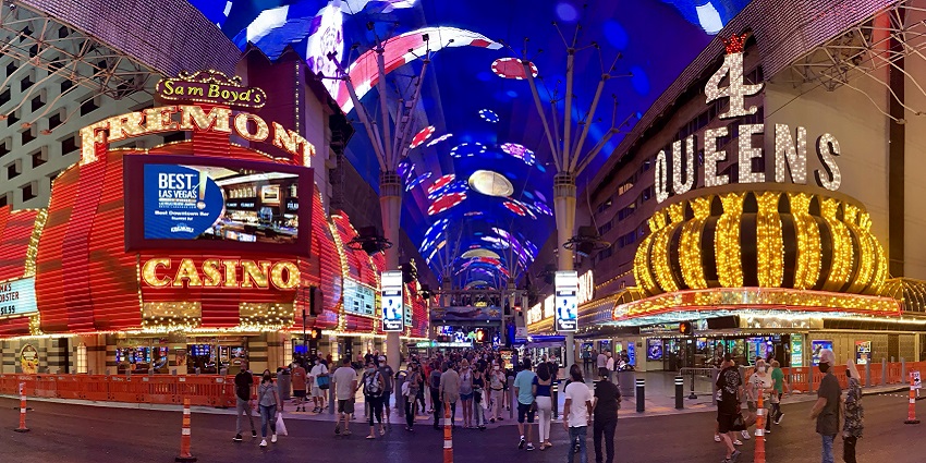 Fremont Street with an LED screen roof, colourful lit signages of casinos and people