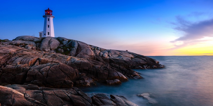 A lighthouse during sunset near the sea - one of the things to do in Nova Scotia in October.