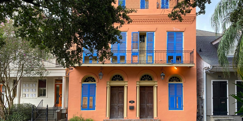 French Quarters showcasing historical buildings and a man, woman and dog on the street