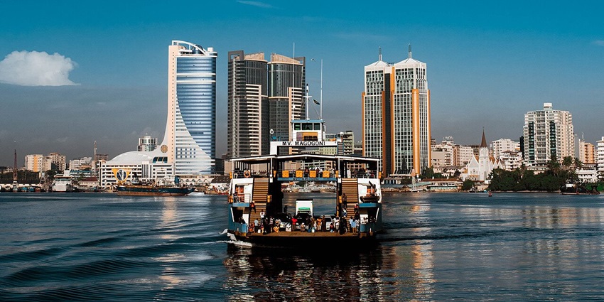 A boat carries people across the river to Dar es Salaam - among the things to do in Tanzania.