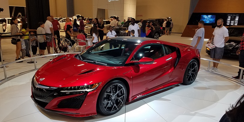 Visitors watch a supercar on exhibition at the Miami International Auto Show in Florida, USA