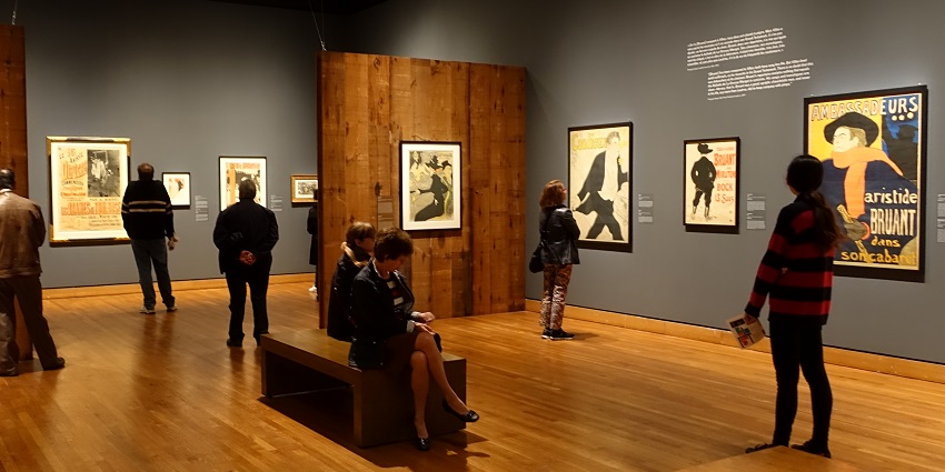 Interior of Montreal Museum of Fine Arts with exhibits on walls and people visiting