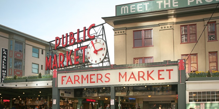 Street view of Pike Place Market showcasing signboards like Public Market and Farmers Market