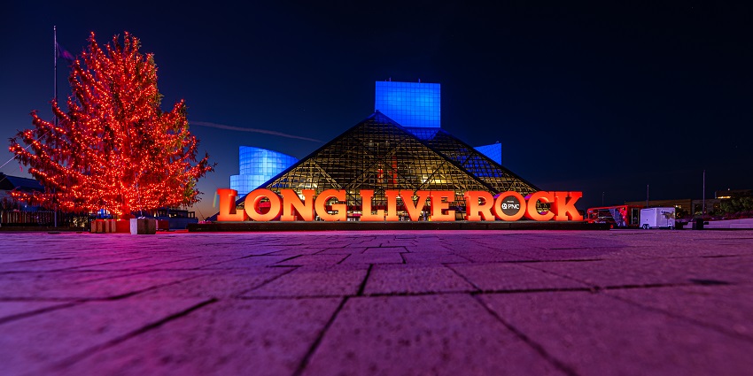Rock and Roll Hall of Fame with big and bright live long rock signage and a bright tree