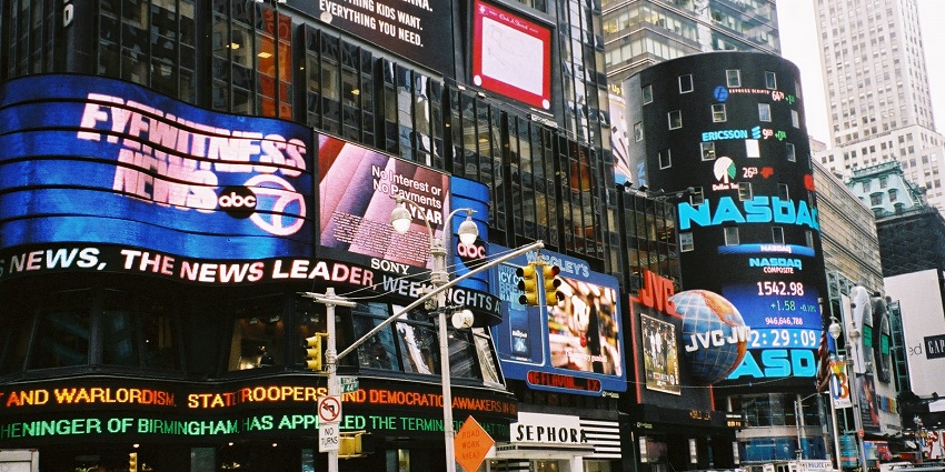 An image of Times Square in New York City with bright billboards, busy streets, one among the best things to do in NYC for valentines day.