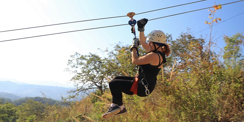 A representative image of a girl enjoying mountain zipline adventure sports in Pune