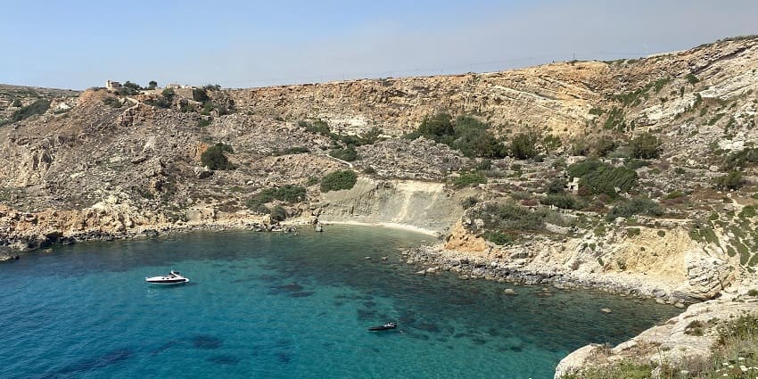 Clean blue waters at Fomm ir-Riħ Bay in Northwestern Malta for travellers to explore.