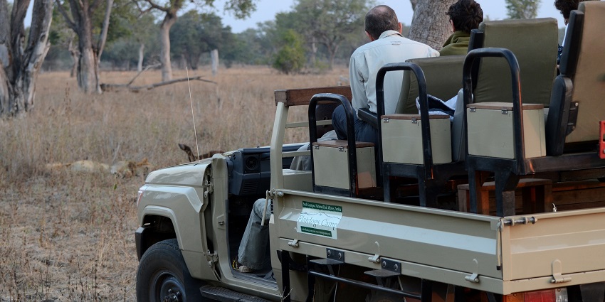 A safari jeep filled with tourists in South Luangwa National Park in Zambia.