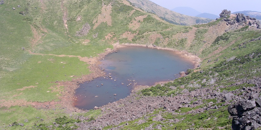 Sangumburi Crater showcases greenery and stunning volcanic landscape views.
