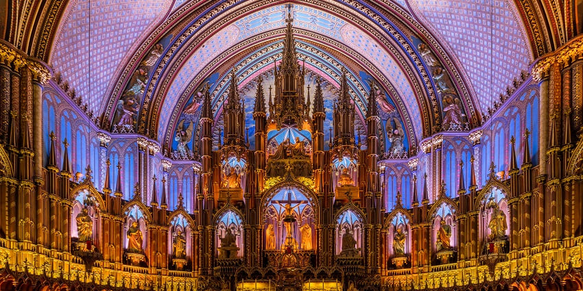 Inside Basílica de Notre-Dame of Montreal with detailed architecture and carvings