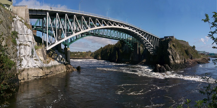 An arched bridge over the confluence of St John River and Bay of Fundy in Nova Scotia.