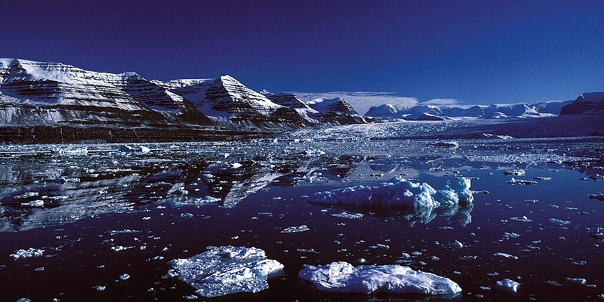 Reflection of a snow-covered mountain in Scoresby Sund has created a perfect mirror image.