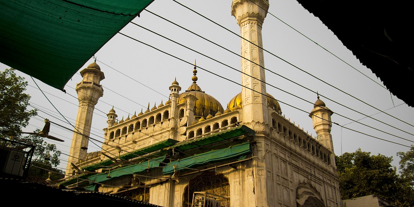 Unique golden-themed mosque reflecting vibrant Islamic art and design.