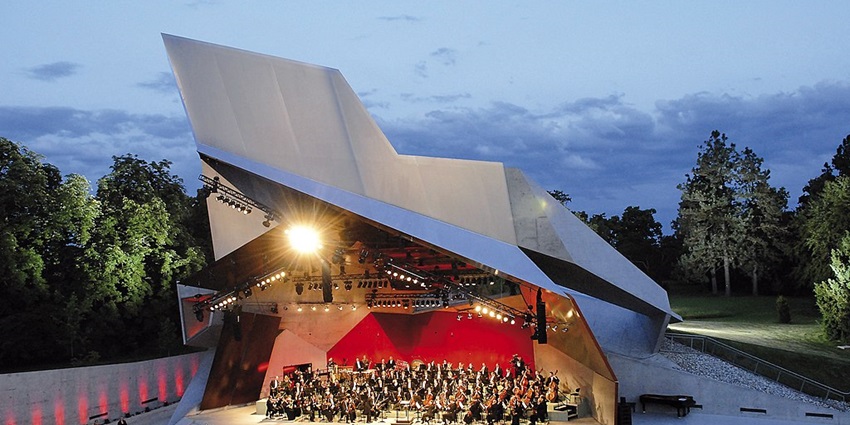 A poster for the Grafenegg Festival, showcasing a classical music performance in the idyllic setting of Schloss Grafenegg
