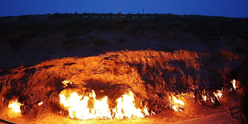 Explore the grandeur of Yanar Dag, a natural gas fire continuously burning on a hillside.