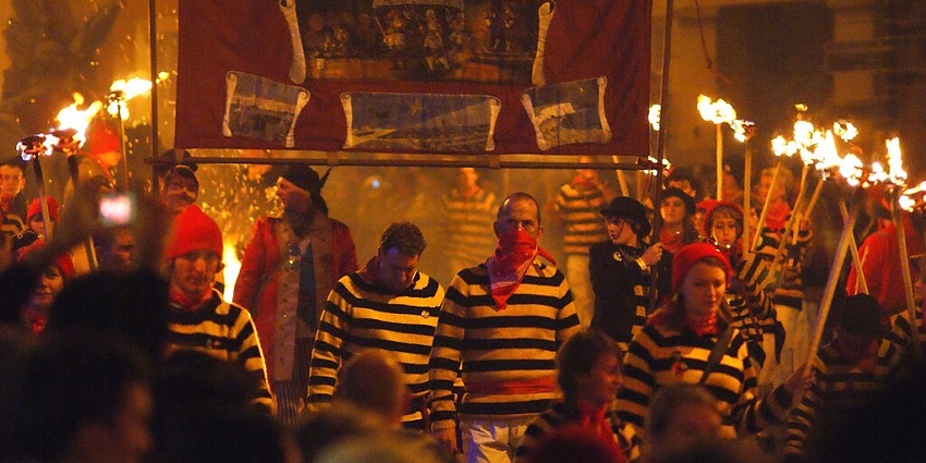 An Image of the masked men and women, celebrating Guy Fawkes Night, a major festival in England.