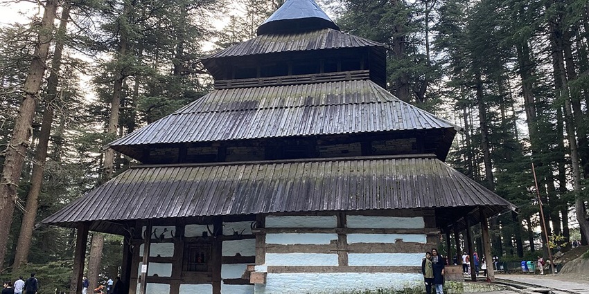 An ancient wooden temple surrounded by lush forests and mountains is a must-visit according to the Kullu Manali travel guide.