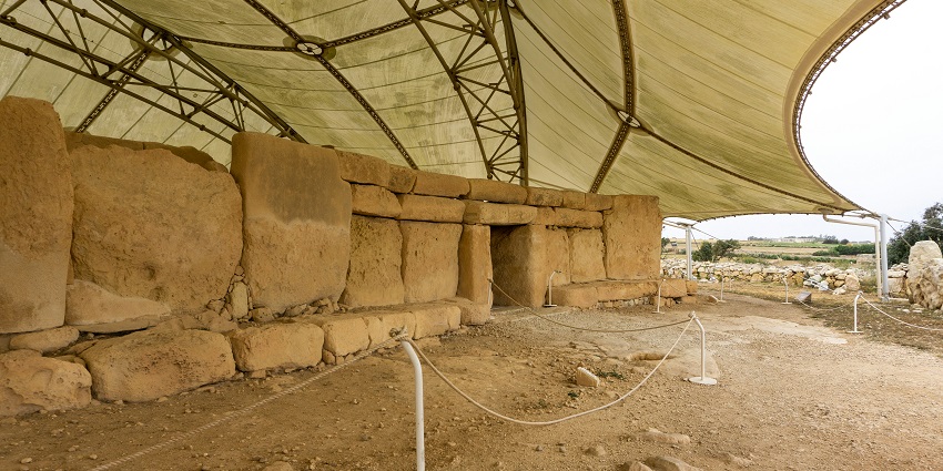 The ruins of the Hagar Qim Temples in Malta are being watched and explored by tourists.