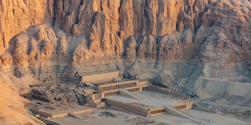 An aerial view picture of the Hatshepsut Temple taken during sunrise located in Luxor.