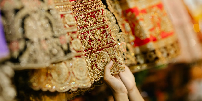 Image of a person holding a red embroidered fabric - Shopping in Lucknow