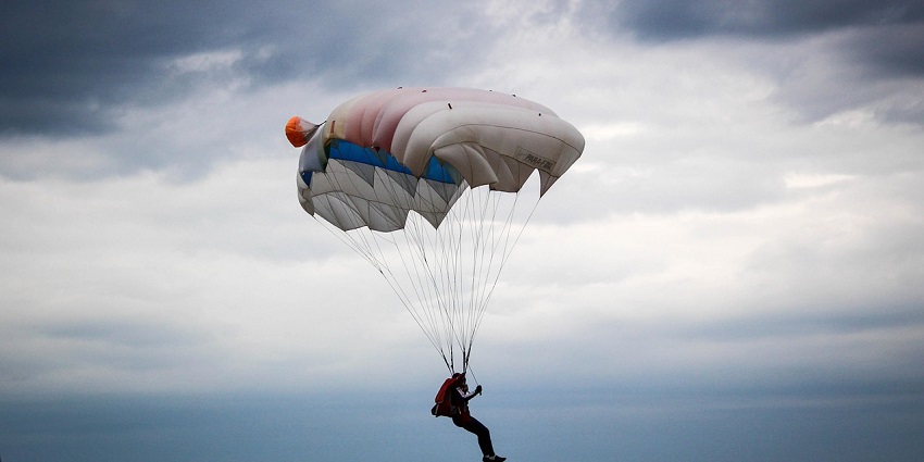 An image showing a man mid-air skydiving, capturing the thrill and excitement of the dive