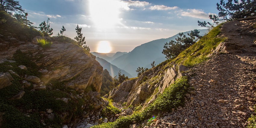 A breathtaking view of Mount Olympus with rays of sunlight falling on it in the day.