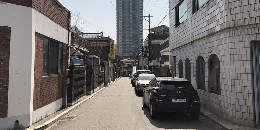 Quaint village with murals, cafes, and scenic Seoul views.