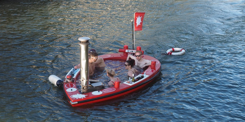 An image of people relaxing in a hot tub boat is among the best date ideas for Valentine’s Day in Seattle