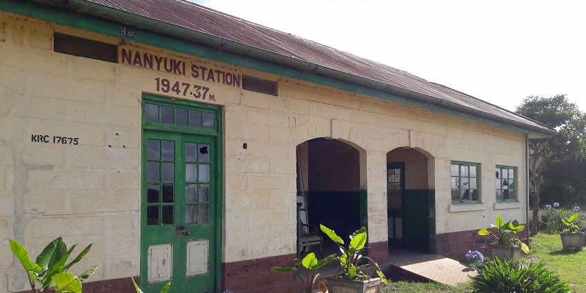 The entrance of the Nanyuki railway station with small plant pots outside the building.