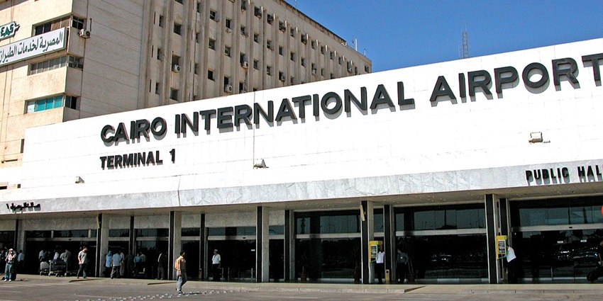 A sign showcasing the name of Cairo International Airport and terminal one entrance.