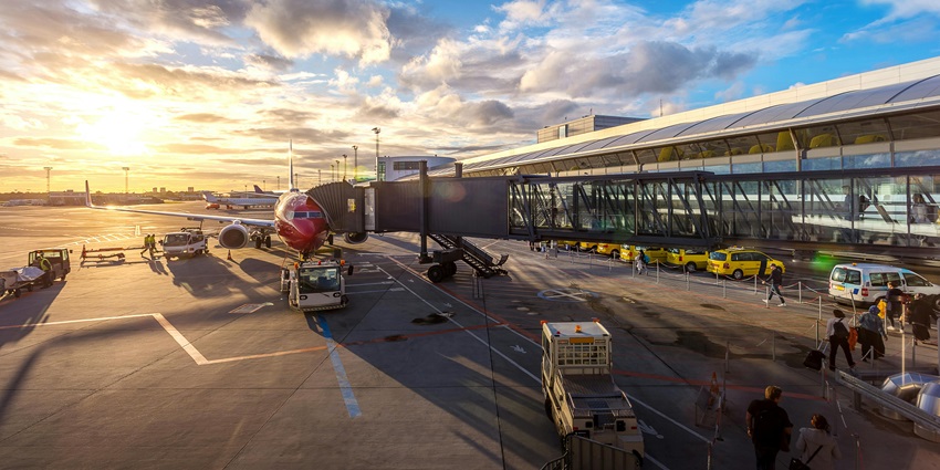 Image of na airport with beautiful sunset and onboarding passengers into the plane