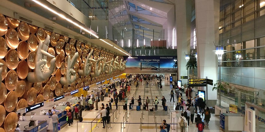 Travellers queue up in the Terminal 3 building in Indira Gandhi International Airport in Delhi.