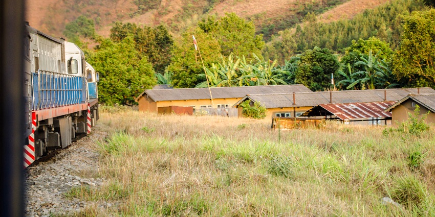 Iringa town railway station platform from the train with yellow walls and grey roofs