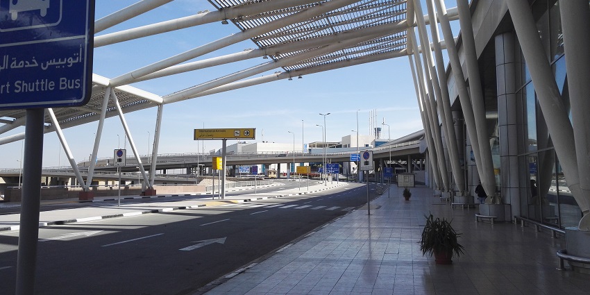 A sign of shuttle bus service is placed outside the Cairo International Airport