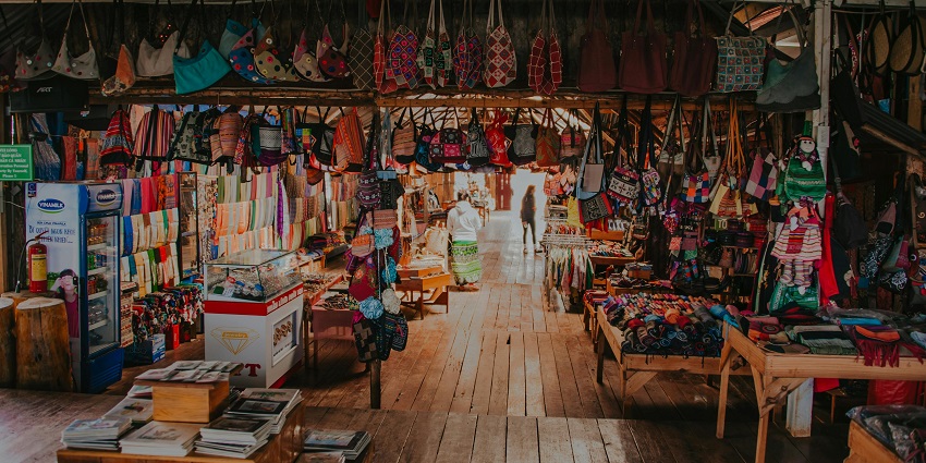 Image of a market selling colourful hanging bags and other handcrafted items