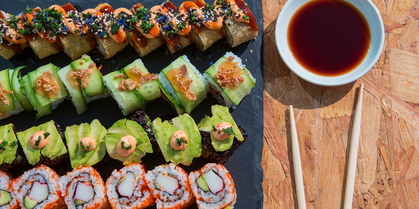 Vibrant and colourful sushis served with dipping sauce and a pair of chopsticks