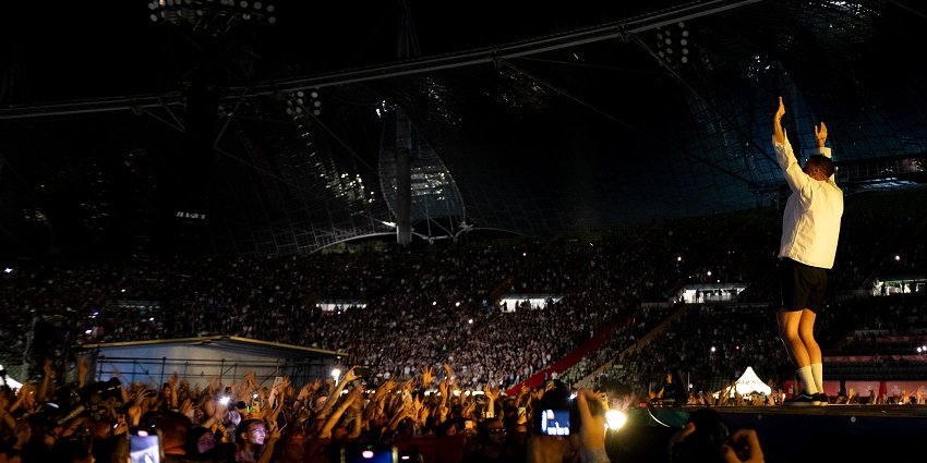 Image of Imagine Dragons performing at a festival in the USA, showcasing energy.