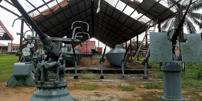 Image of war equipments displayed and tanks on the back giving historical significance