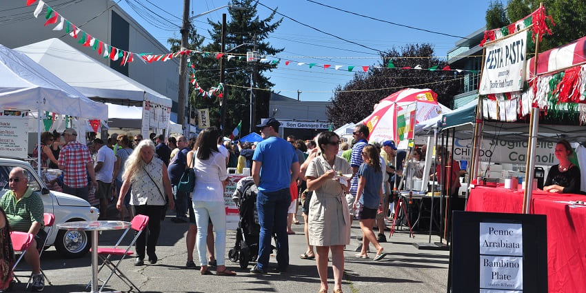 Image of a street and open shops markets during a festival - people enjoying