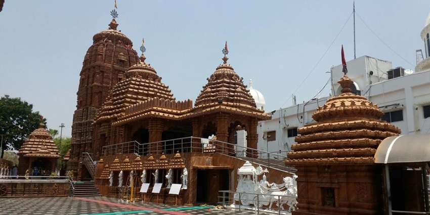 Red sandstone Jagannath Temple in Hyderabad with carved towers and open courtyard