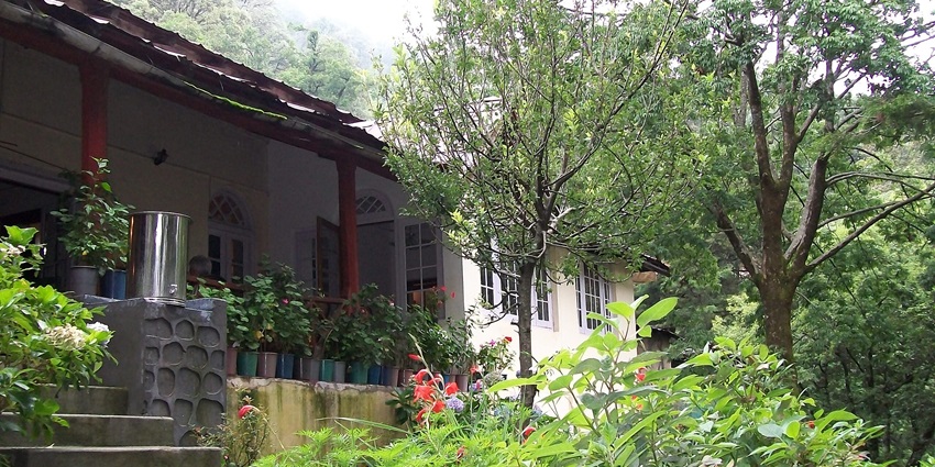 Colonial‑style Gurney House at Ayarpatta Hill, Nainital, surrounded by lush garden.