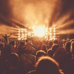 An image of a diverse crowd enjoying live performances at a major music festival in the USA.